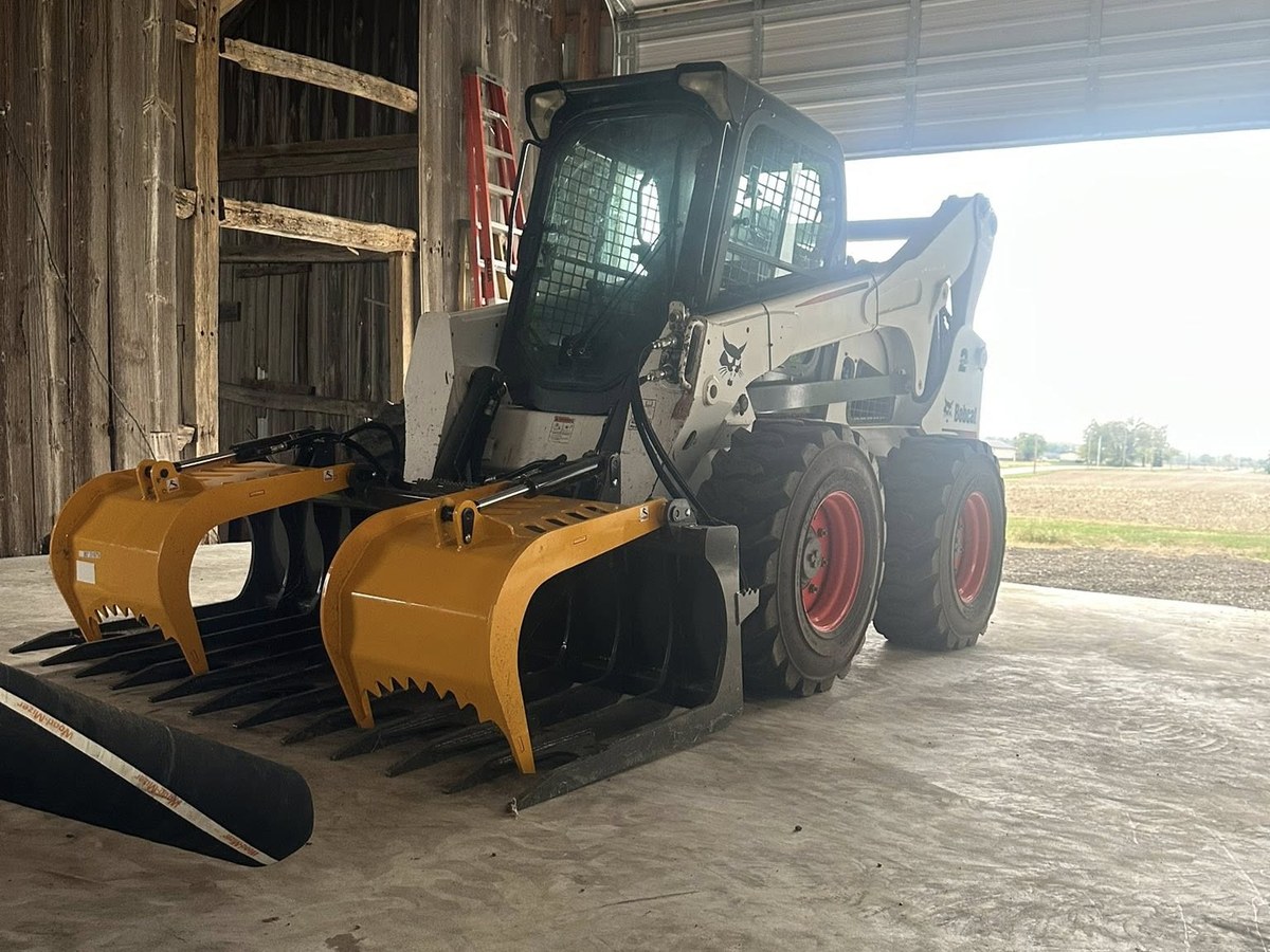 2016 Bobcat S850 skid steer with grapple bucket attachment — Vail Wood Products skid steer services, Butler, Indiana